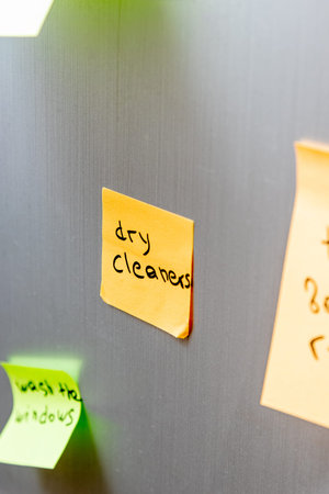 Reminder sticker glued to the refrigerator door to take dirty clothes to dry cleaners to be washed
