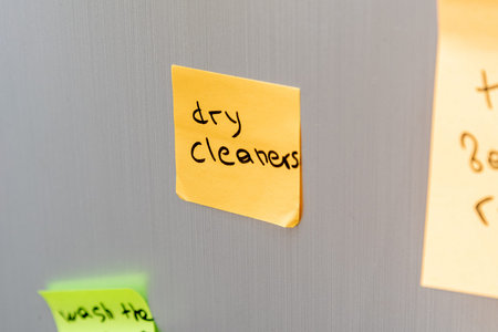 Reminder sticker glued to the refrigerator door to take dirty clothes to dry cleaners to be washed
