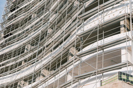 Building under construction with scaffolding, view of the construction site of multistorey frame...