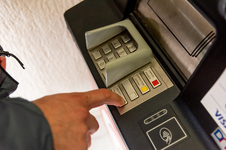 Bar, Montenegro, 6 March 2026, Man withdraws money from bank card at an ATM terminalのeditorial素材