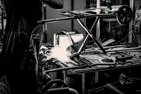 Saint Petersburg, Russia, 7 May 2019, Man repairing broken wheelchair in workshop