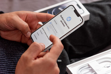 Bar, Montenegro, 2 November 2025, Man sets up new iPhone, first launch of smartphone