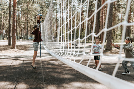 Saint Petersburg, Russia, 18 June 2021, Kids teens playing amateur volleyball on outdoor stadium