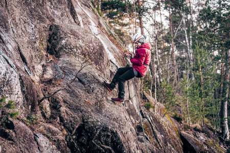 Saint Petersburg, Russia, 4 January 2020, Rock climber climbing high rock wall extreme sports...