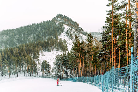 Krasnoyarsk, Russia, 9 January 2021, Snowboarder skier sliding down snowy slope, rider relaxing at...