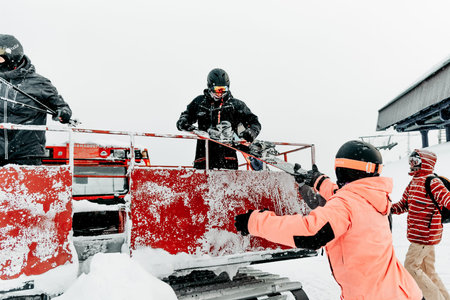 Sheregesh, Russia, 4 January 2021, Snowboarder skier getting out of snowcat on snowy mountain ski...