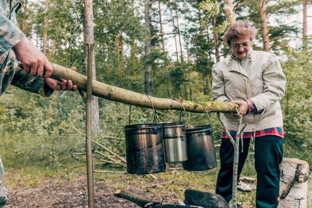 Saint Petersburg, Russia 6 June 2020, Woman tourist cooking food on campfire bonfireのeditorial素材
