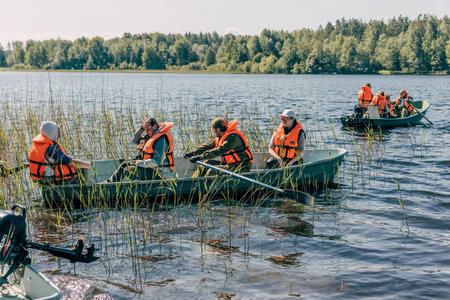 Karelia, Russia, 7 June 2020, Tourists sail on wooden boats skiffs on Lake Ladoga