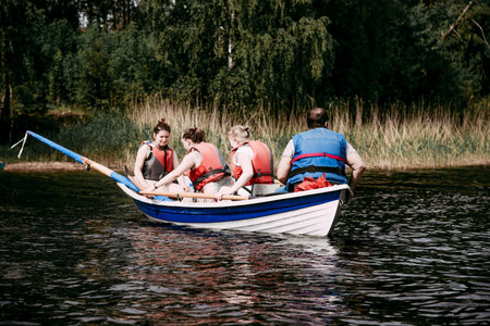 Karelia, Russia, 9 June 2019, Tourists sail on wooden paddle boats skiffs on Lake Ladoga