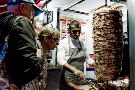 Istanbul, Turkey, 8 May 2018, Chef prepares meat chicken dener on spit barbecueのeditorial素材