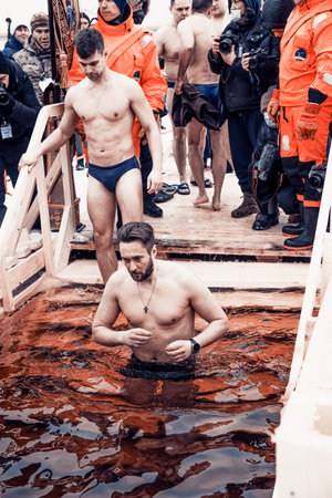 Saint Petersburg, Russia, 19 January 2022, People plunge into the font in the river on the Orthodox...