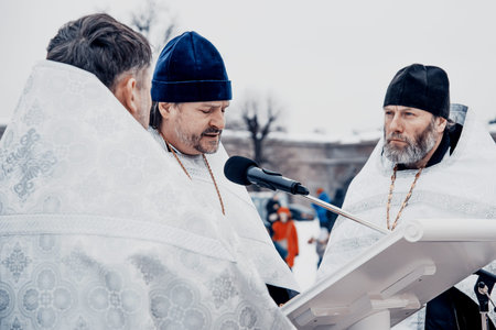 Saint Petersburg, Russia, 19 January 2022, Priest consecrating river water for baptism, holy father...