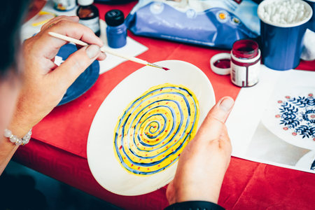 Saint Petersburg, Russia, 27 July 2019, Person drawing Painting Porcelain Plate with Colorful Paints, Art Design Creativeのeditorial素材