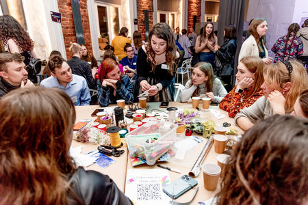 Saint Petersburg, Russia, 19 March 2022, People makes craft from colored paper, human draw education