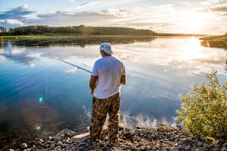 Kemerovo, Russia, 13 July 2017, Man fisherman with fishing rod fishing in river fishing lake waterscapeのeditorial素材
