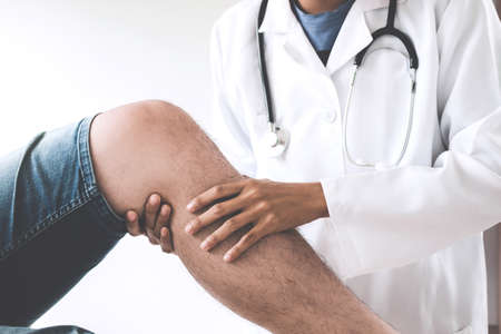 Doctor checking patient with knees to determine the cause of illness.
