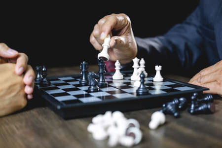 Businessman and businesswoman playing chess and thinking about strategy crash overthrow the opposite team and development analysis for win and successful.の写真素材