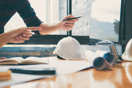 Team of Construction engineering or architect hands working on blueprint inspection in workplace, drawing and sketching meeting for architectural project working with partner.の写真素材