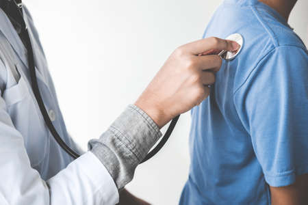 Doctor checking patient with stethoscope listening to heartbeat, Healthcare and medical concept.の写真素材
