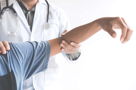 Doctor checking patient with elbow to determine the cause of illness.の写真素材