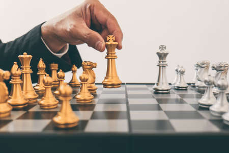 Businessman leadership playing chess and thinking strategy plan about crash overthrow the opposite...