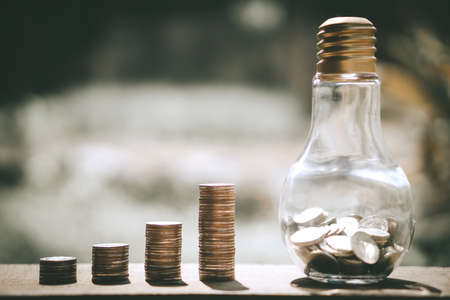 Coin stacks for step up growing business to profit and saving with bottle glass bank.の写真素材