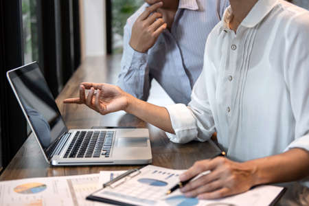 Businessman accountant and secretary making working audit and calculating expense financial annual financial report balance sheet statement, doing finance making notes on paper checking inspection.の写真素材