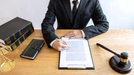 Legal law, advice and justice concept, male lawyer or notary working on a documents and report of...