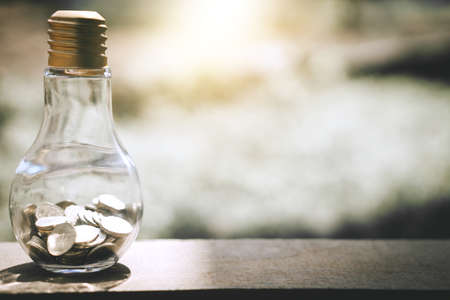Coin stacks into bottle glass bank for step up growing business to profit and saving concept.の写真素材
