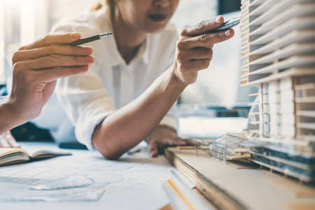 Team of Construction engineering or architect hands working on blueprint inspection in workplace, drawing and sketching meeting for architectural project working with partner.の写真素材