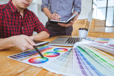 Team of Creative graphic designer meeting working on new project, choose selection color and drawing on graphics tablet with work tools and accessories.の写真素材