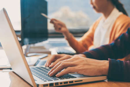 Professional Development programmer cooperating meeting and brainstorming and programming website working in a software and coding technology, writing codes and data code.の写真素材