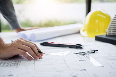 Construction engineering or architect hands working on blueprint inspection in workplace, while...