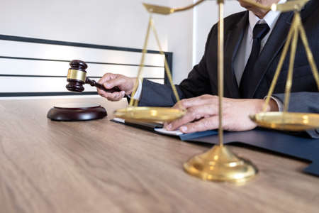 Law, lawyer attorney and justice concept, male lawyer or notary working on a documents and report of the important case in the law firm.の写真素材