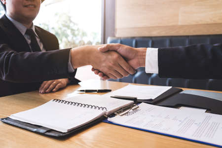 Successful job interview with boss and employee shaking hands after negotiation or interview, career...