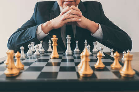 Businessman leadership playing chess and thinking strategy plan about crash overthrow the opposite team and development analyze for successful of corporate.の写真素材
