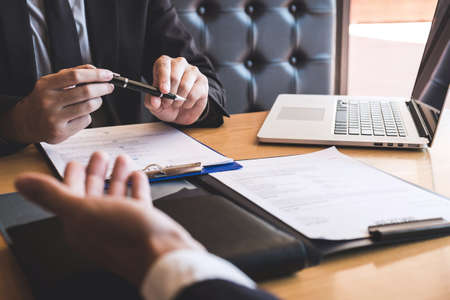 Employer or recruiter holding reading a resume during about his profile of candidate, employer in suit is conducting a job interview, manager resource employment and recruitment concept.の写真素材
