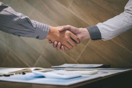 Finishing up a conversation after collaboration, handshake of two business people after contract agreement to become a partner, collaborative teamwork.の写真素材