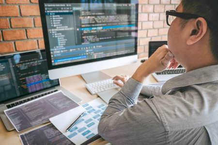 Professional Developer programmer working a software website design and coding technology, writing codes and database in company office, Global cyber connection technology.の写真素材