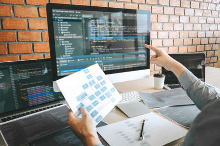 Professional Developer programmer working a software website design and coding technology, writing codes and database in company office, Global cyber connection technology.の写真素材