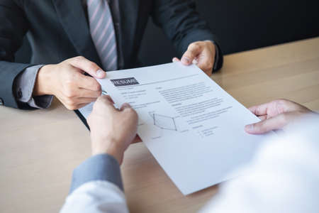 Employer or recruiter holding reading a resume during about colloquy his profile of candidate,...