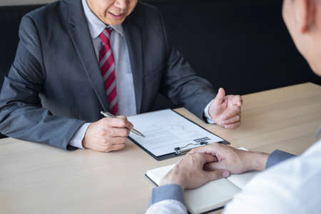 Employer or recruiter holding reading a resume during about colloquy his profile of candidate,...