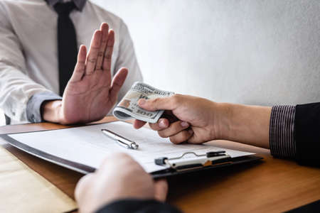 Anti bribery and corruption concept, Business man refusing and don't receive money banknote in...