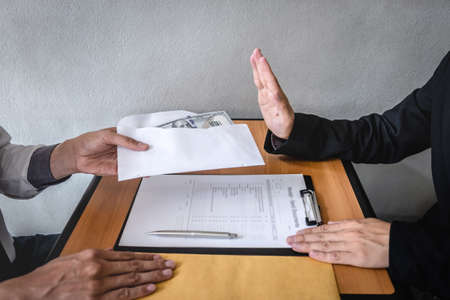 Anti bribery and corruption concept, Business man refusing and don't receive money banknote in...