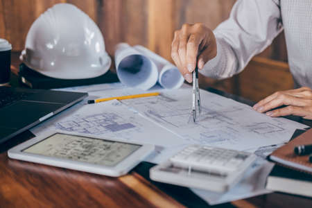 Construction engineering or architect hands working on blueprint inspection in workplace, while...