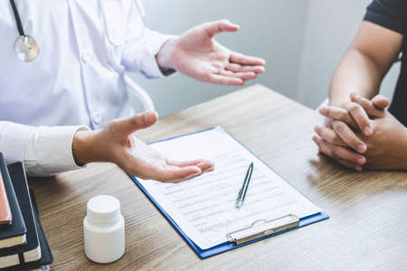 Doctor consulting with patient examining for patient, presenting results symptom about the problem and recommend treatment method, Healthcare and medical concept.の写真素材