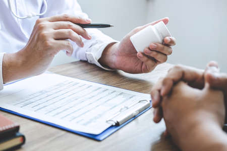Doctor consulting with patient examining for patient, presenting results symptom about the problem and recommend treatment method, Healthcare and medical concept.の写真素材