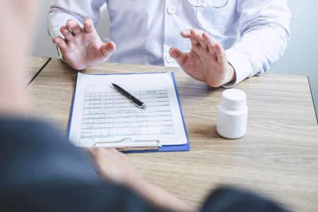 Doctor consulting with patient examining for patient, presenting results symptom about the problem and recommend treatment method, Healthcare and medical concept.の写真素材