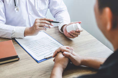 Doctor consulting with patient examining for patient, presenting results symptom about the problem and recommend treatment method, Healthcare and medical concept.の写真素材