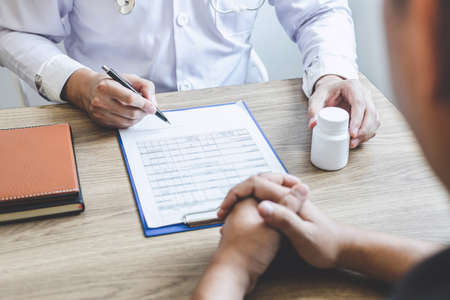 Doctor consulting with patient examining for patient, presenting results symptom about the problem and recommend treatment method, Healthcare and medical concept.の写真素材